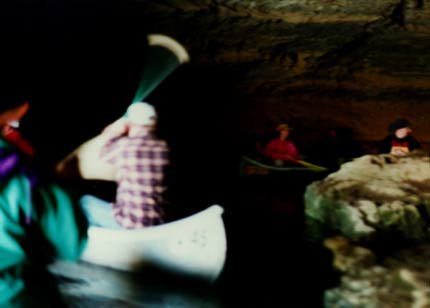 People in canoes in a cave