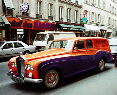 An orange and purple painted Rolls-Royce automobile