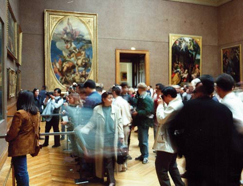 A herd of tourists surrounded by artwork